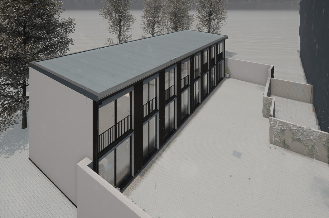 Modernes grau schwarzes Containergebäude mit Glasfront im Hof bei Schnee
