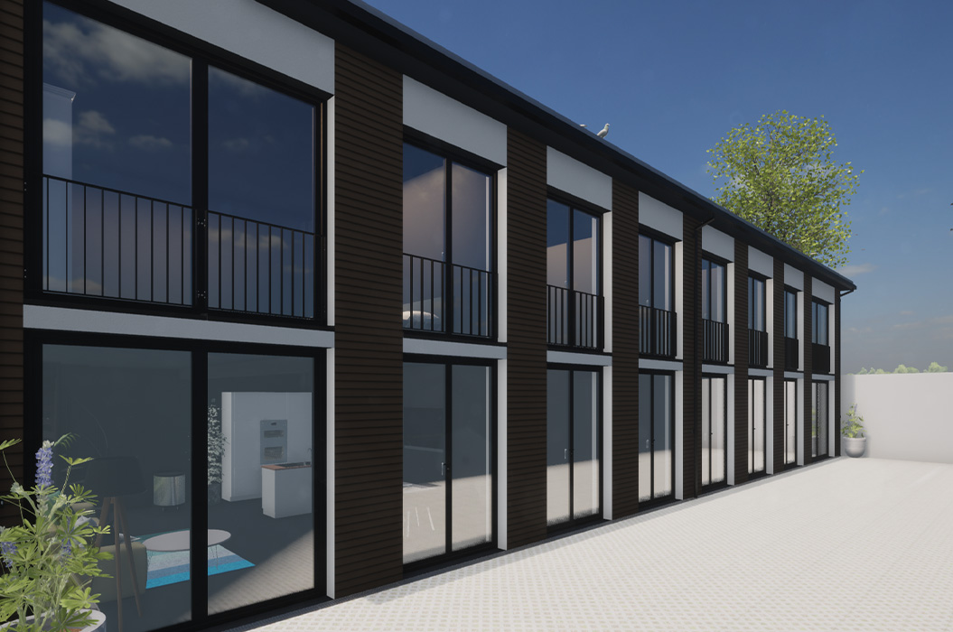 Modernes Reihenhaus mit dunkler Fassade und großen Glasfronten im Blau