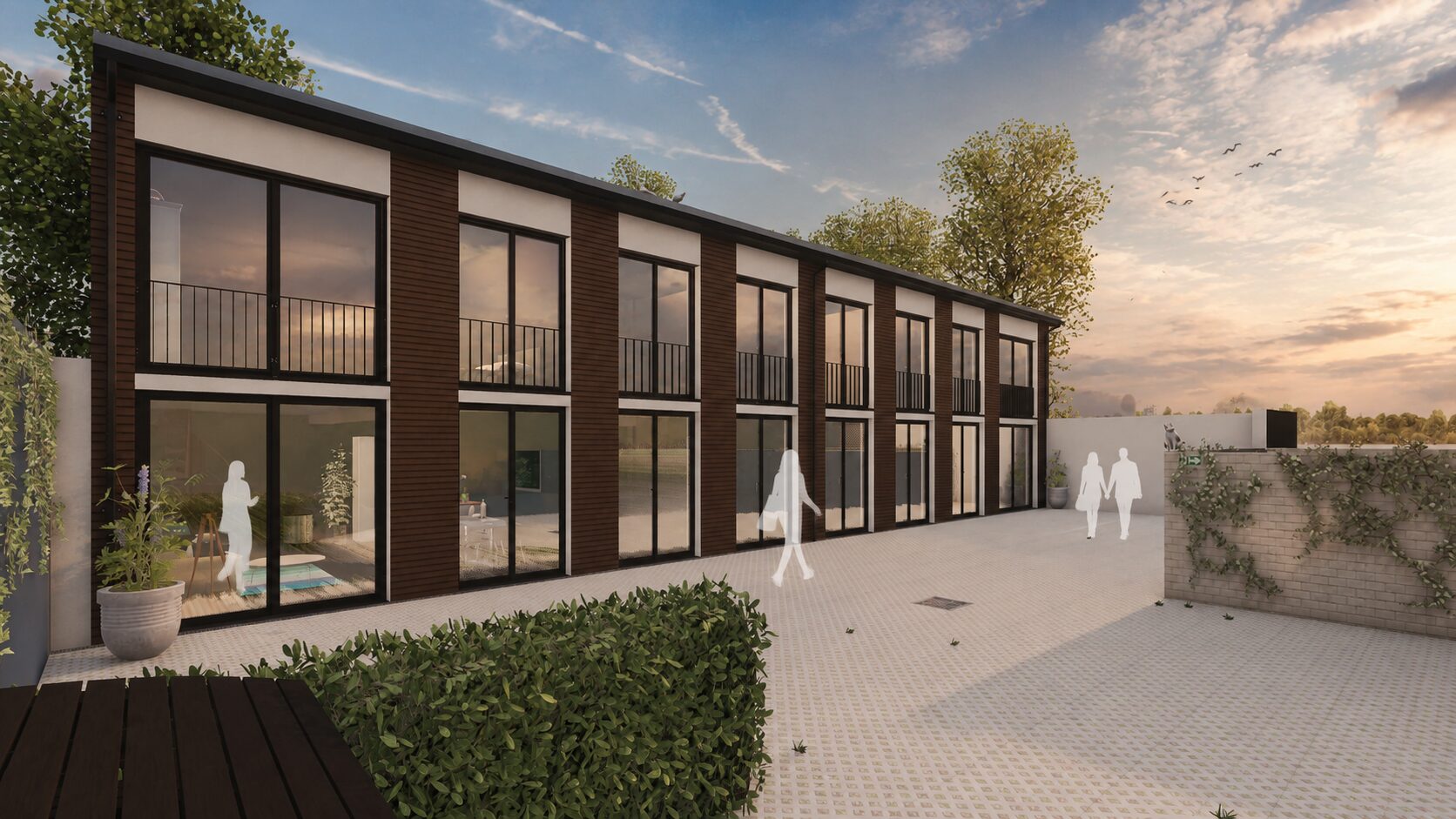 Modernes zweistoeckiges Wohngebaeude mit Holzfassade und grossen Fenstern bei Sonnenuntergang